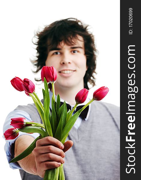 A young boy with a bouquet of red tulips. A young boy with a bouquet of red tulips