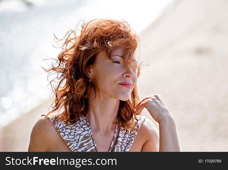 Portrait of red-haired adult women in dune at the sea. Portrait of red-haired adult women in dune at the sea