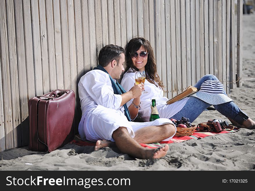 Young couple enjoying  picnic on the beach