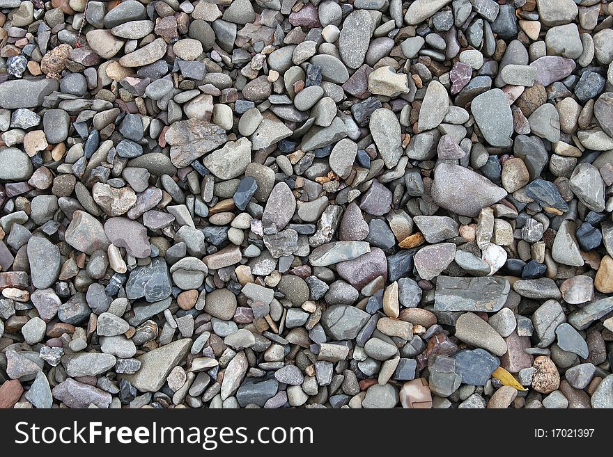 Raw stones lie on the beach on a foggy day