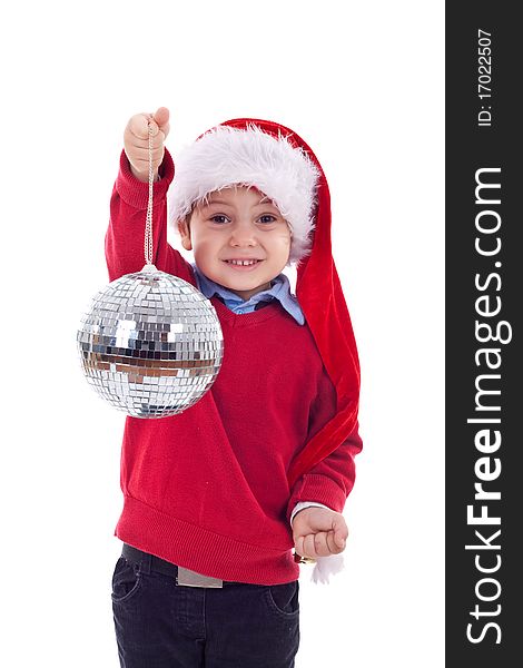 Small boy in Santa's red hat holding a glass disco ball over white. Small boy in Santa's red hat holding a glass disco ball over white