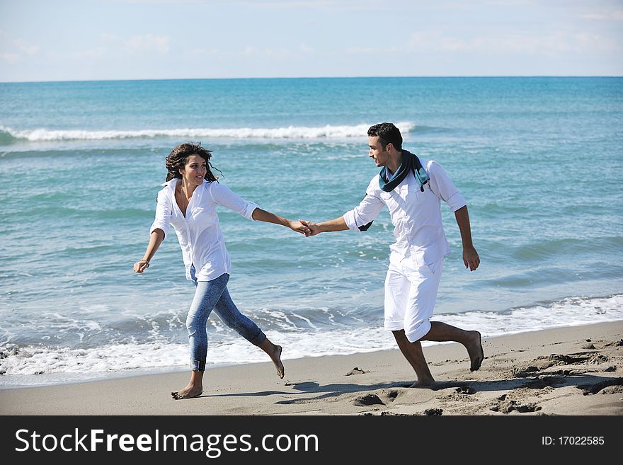 Happy young couple have fun at beautiful beach