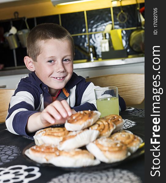 Young Boy reaching for sweets in the kitchen. Young Boy reaching for sweets in the kitchen