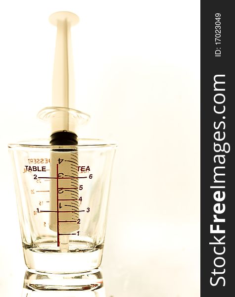 Syringe and medical glass on white background. Syringe and medical glass on white background