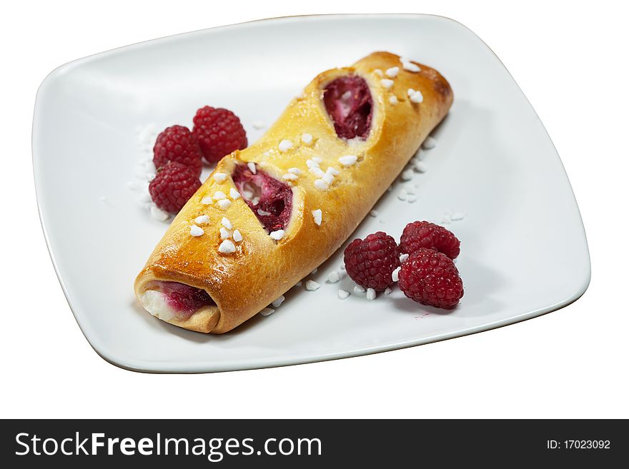 Sweet danish pastry filled with raspberries on white plate isolated. Sweet danish pastry filled with raspberries on white plate isolated