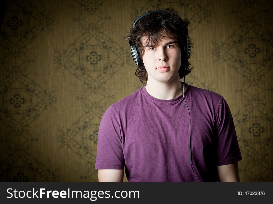 A handsome young man listening to music in headphones