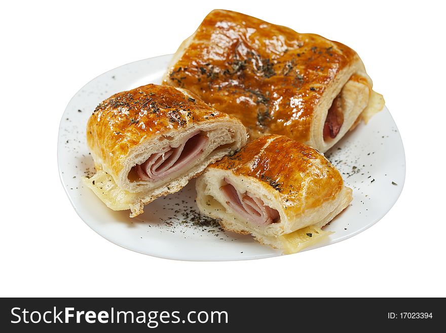 Breakfast pastry filled with ham on white plate isolated. Breakfast pastry filled with ham on white plate isolated