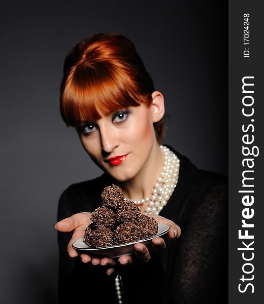 Beautiful elegant fashion woman with chocolate truffle sweets. Beautiful elegant fashion woman with chocolate truffle sweets