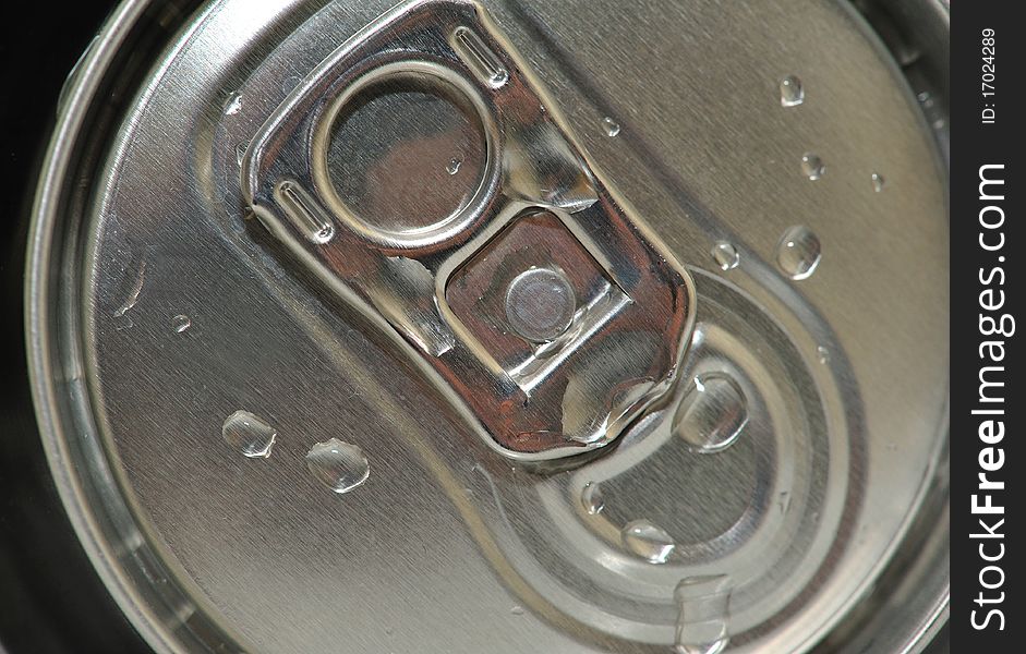 The image is the top of a can, wet from the drops of water, highlight the freshness of the drink. The image is the top of a can, wet from the drops of water, highlight the freshness of the drink.