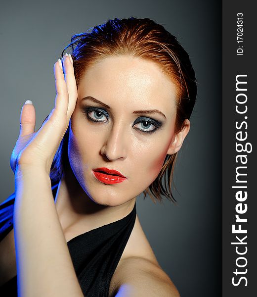 Beautiful desperate woman with perfect bright make-up with red lips and dark shadowed eyes