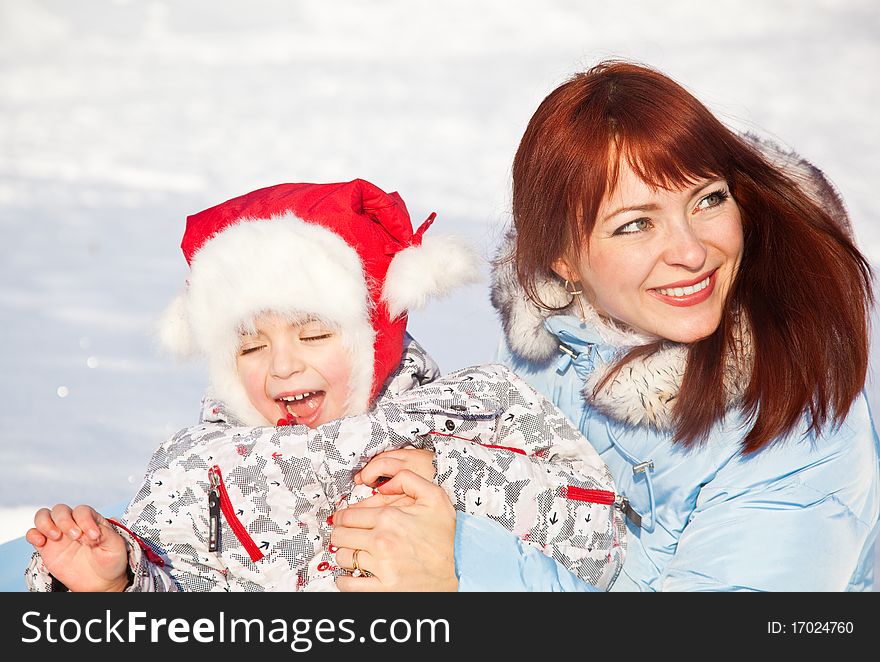 Mother and daughter playing in the snow. Mother and daughter playing in the snow