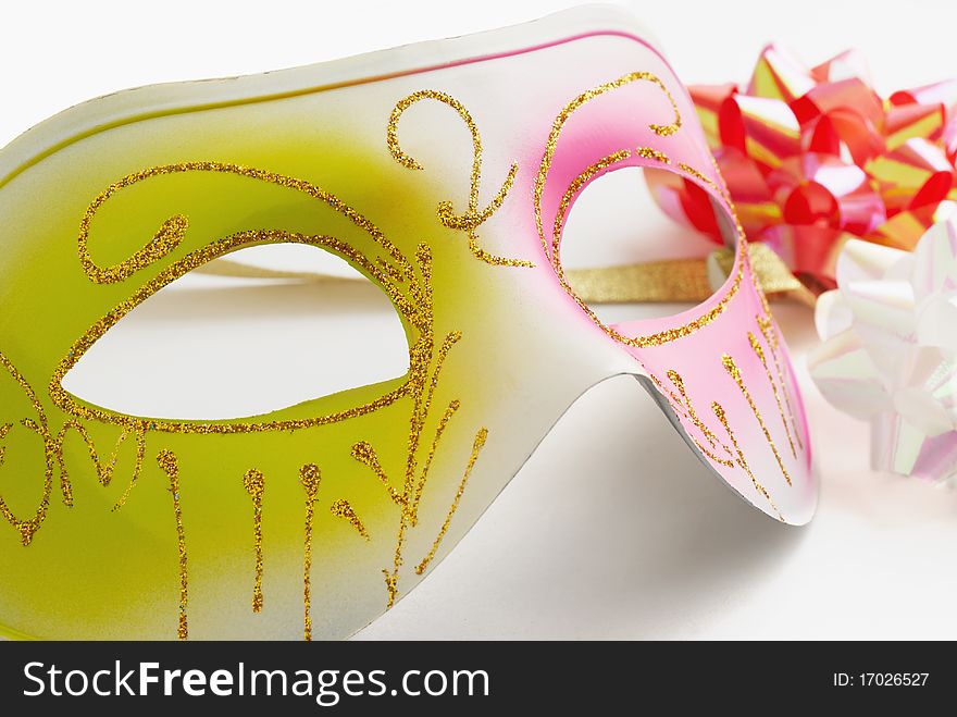 Carnival mask and coloured bows on a white background. Carnival mask and coloured bows on a white background