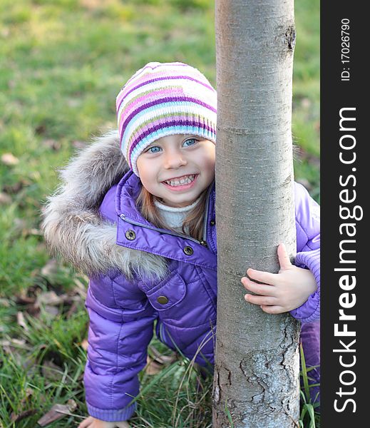 Beautiful little girl laughing outdoors