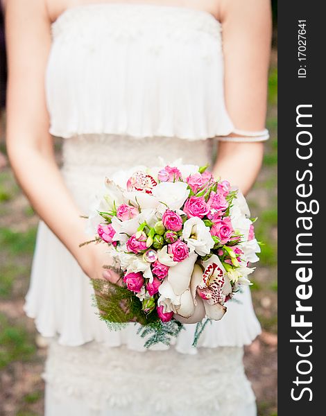 Bride holds bouquet in her hands. Bride holds bouquet in her hands