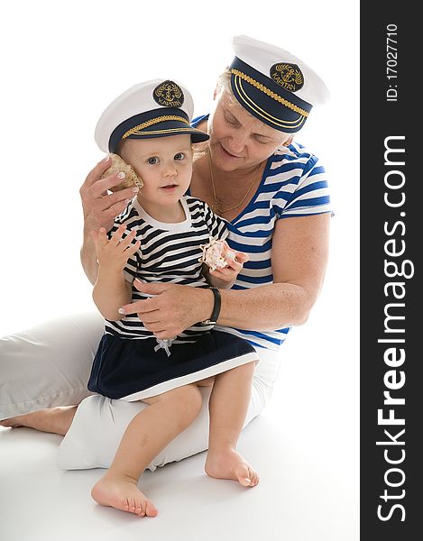 Woman in captain suit playing with baby in studio. Woman in captain suit playing with baby in studio