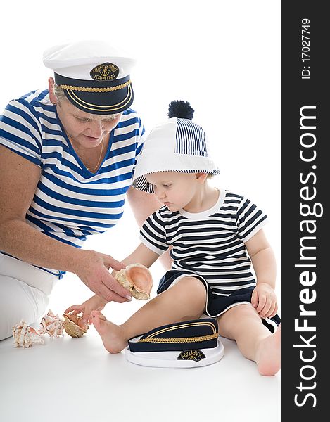 Woman in captain suit playing with baby in studio. Woman in captain suit playing with baby in studio