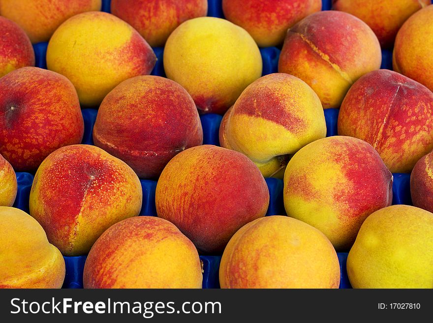 Landscape view of peaches background in the box in a market. Landscape view of peaches background in the box in a market