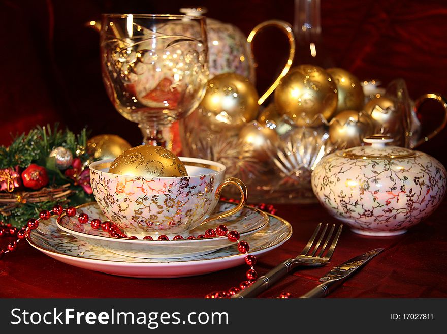 Table with gold dishes on red background. Table with gold dishes on red background