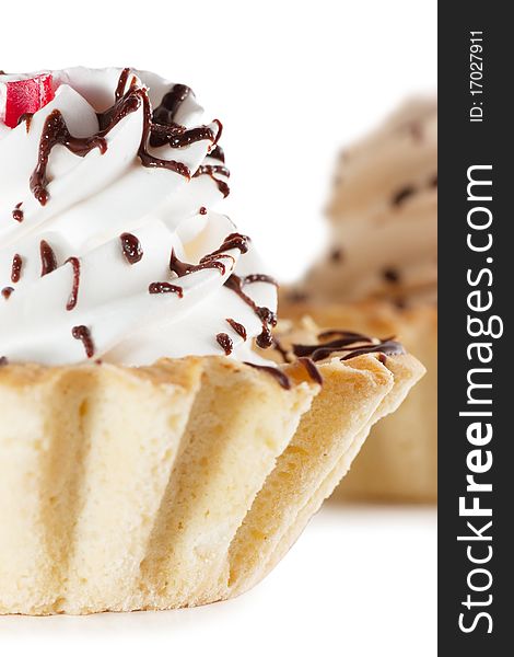 Macro view of cake with whipped cream isolated over white