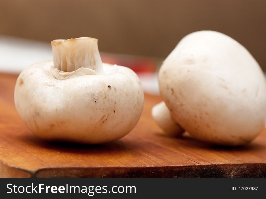 Two mushrooms on a cutting board