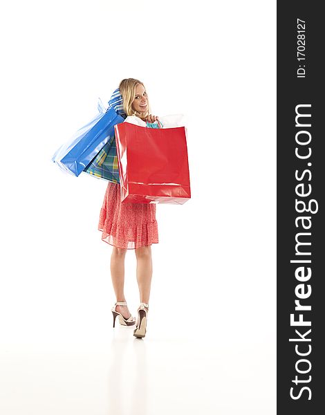 Young woman looking over her shoulder with shopping bags. Young woman looking over her shoulder with shopping bags