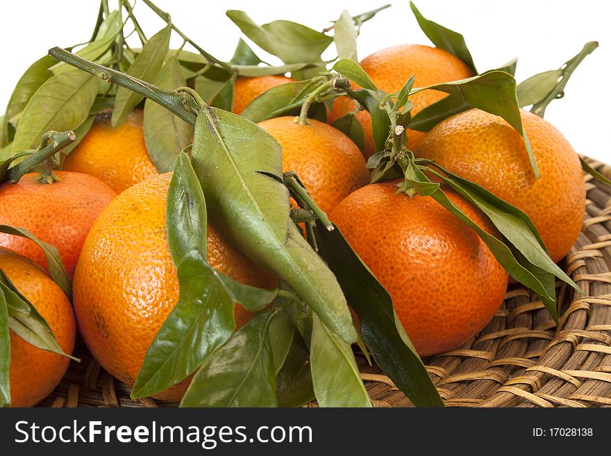 Fresh mandarines on a wicker plate