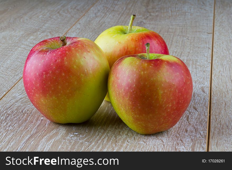 A single apple on a wooden table