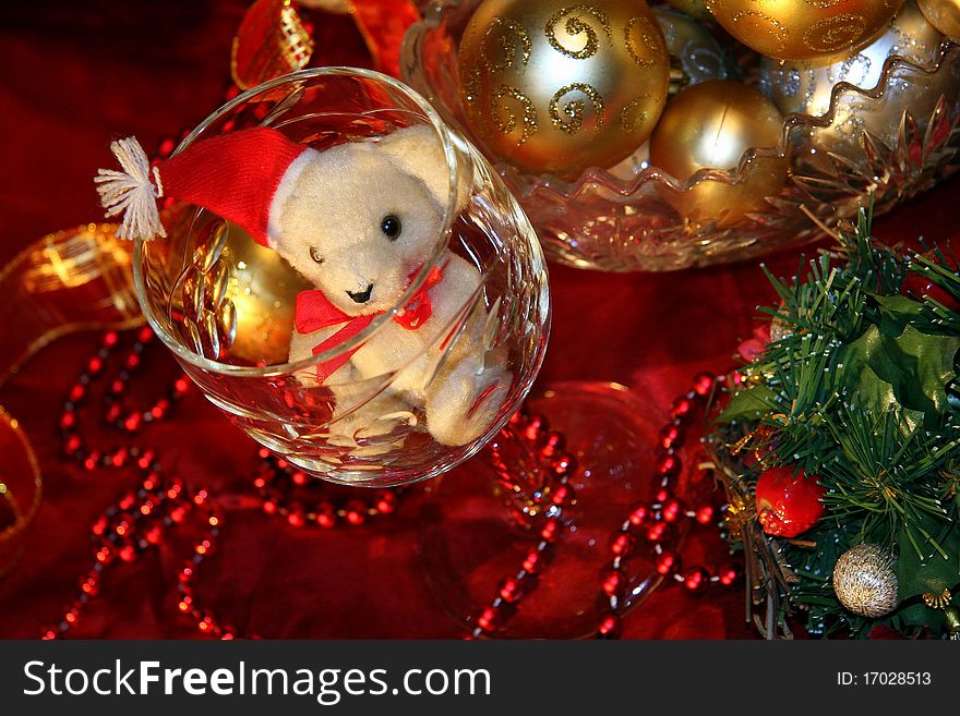 White Teddy bear, a glass of wine and Christmas decorations. White Teddy bear, a glass of wine and Christmas decorations