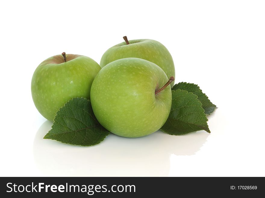 Green apple trio with leaf sprigs, isolated over white background. Granny Smith variety. Green apple trio with leaf sprigs, isolated over white background. Granny Smith variety.