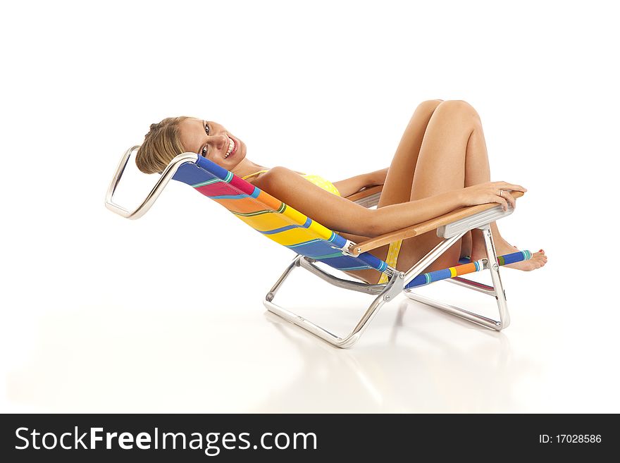 Young woman with yellow bikini lying in beach chair. Young woman with yellow bikini lying in beach chair