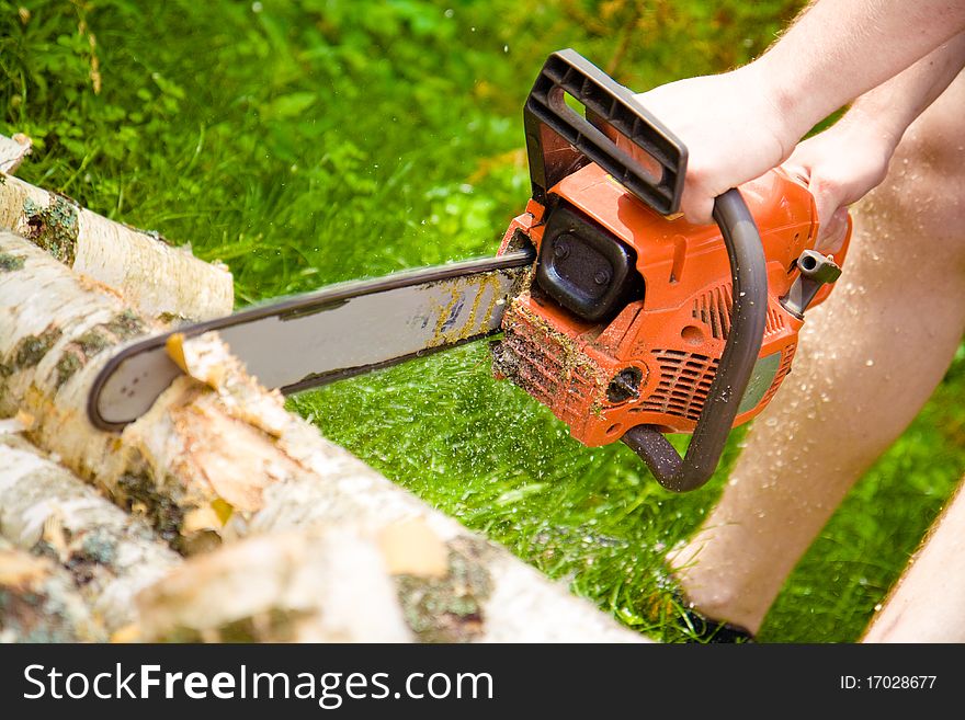 Man uses a gasoline-powered saw