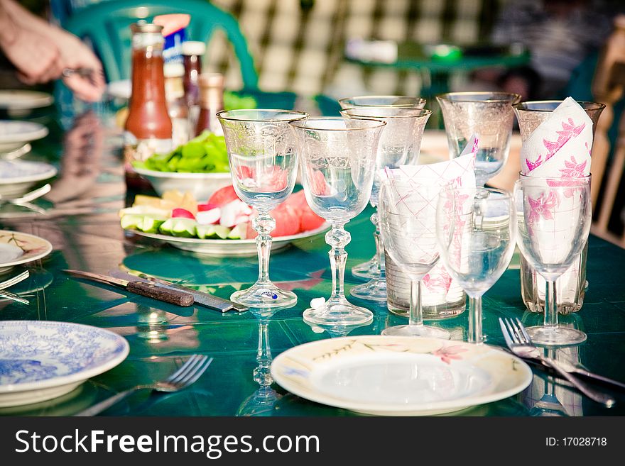 Wine glasses and plated on a green table. Wine glasses and plated on a green table