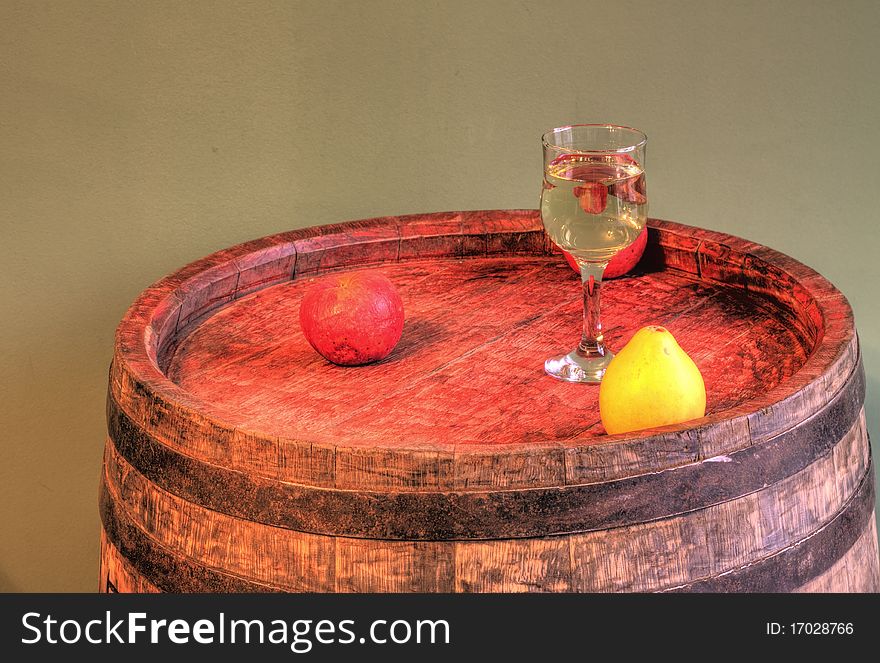 A glass of white wine and fruits. A glass of white wine and fruits