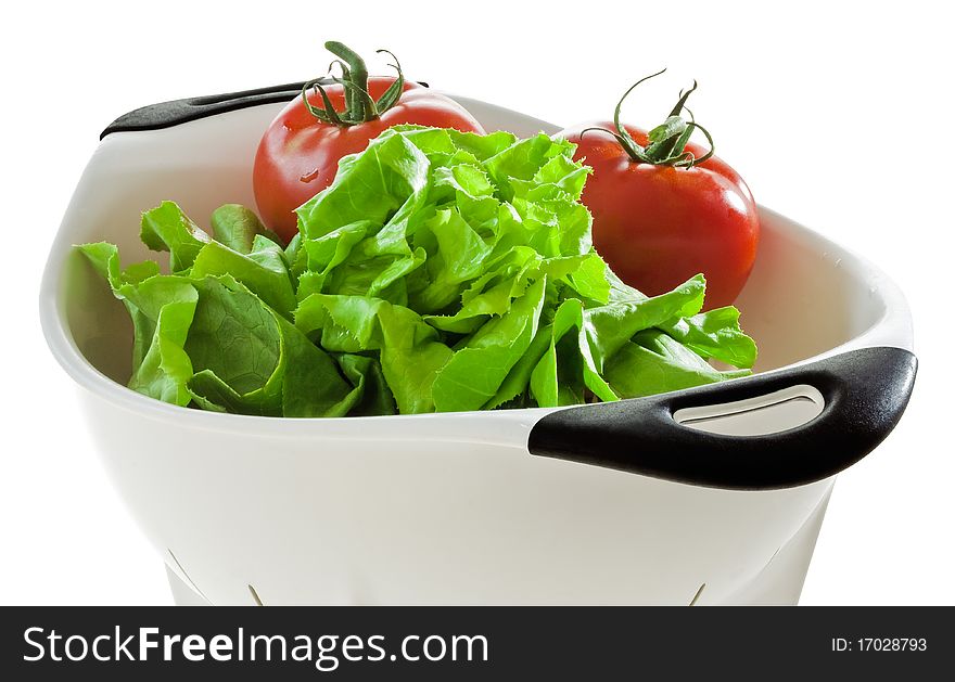 Lettuce and tomatoes in a colander