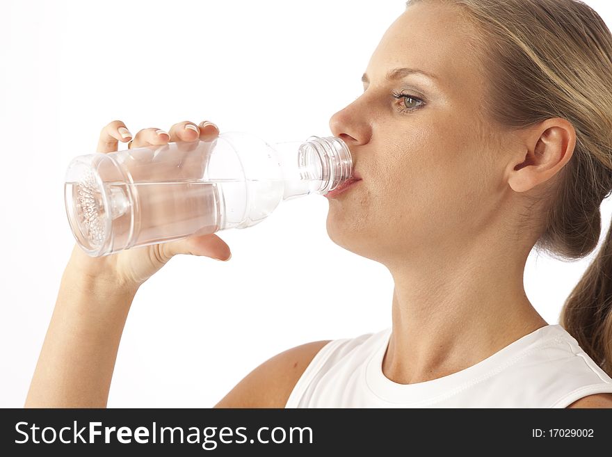 Young woman drinking water from bottle. Young woman drinking water from bottle