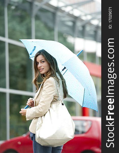 Beautiful woman holding a blue umbrella. Beautiful woman holding a blue umbrella