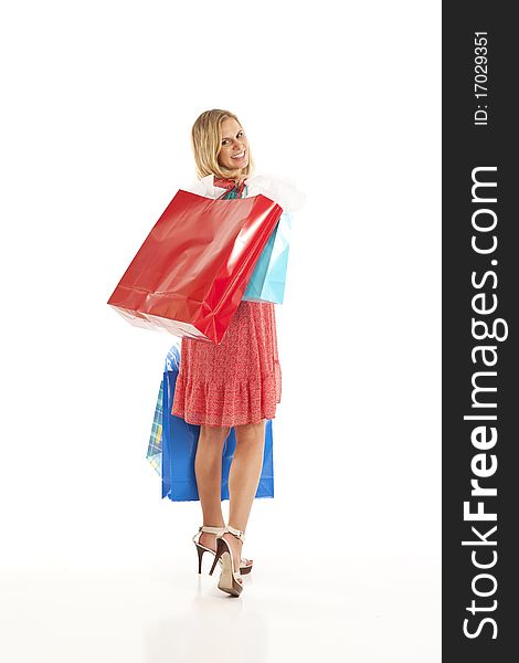 Young woman looking over her shoulder with shopping bags. Young woman looking over her shoulder with shopping bags