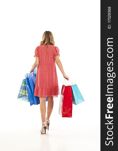 Back view of young woman with shopping bags