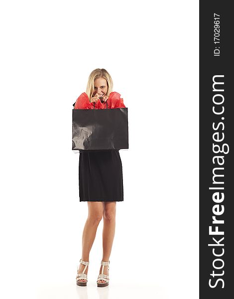 Young woman in black with red and black shopping bag. Young woman in black with red and black shopping bag