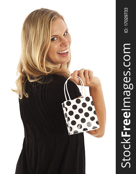 Close up portrait of young woman in black with small black and white shopping bag. Close up portrait of young woman in black with small black and white shopping bag