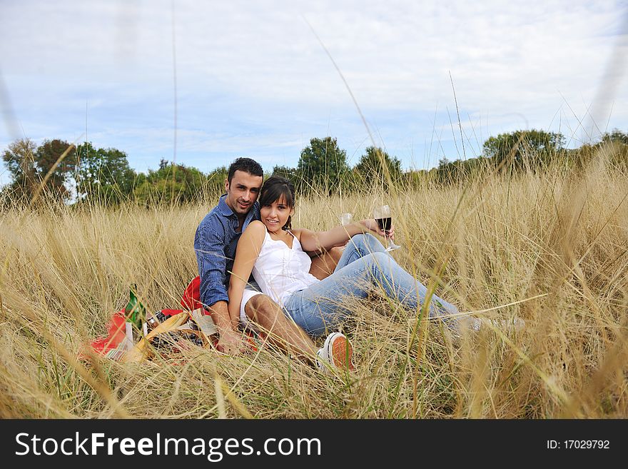 Happy young couple enjoying  picnic on the countryside in the field  and have good time. Happy young couple enjoying  picnic on the countryside in the field  and have good time
