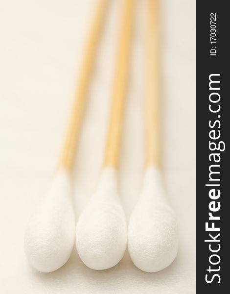 Three cotton buds on white background