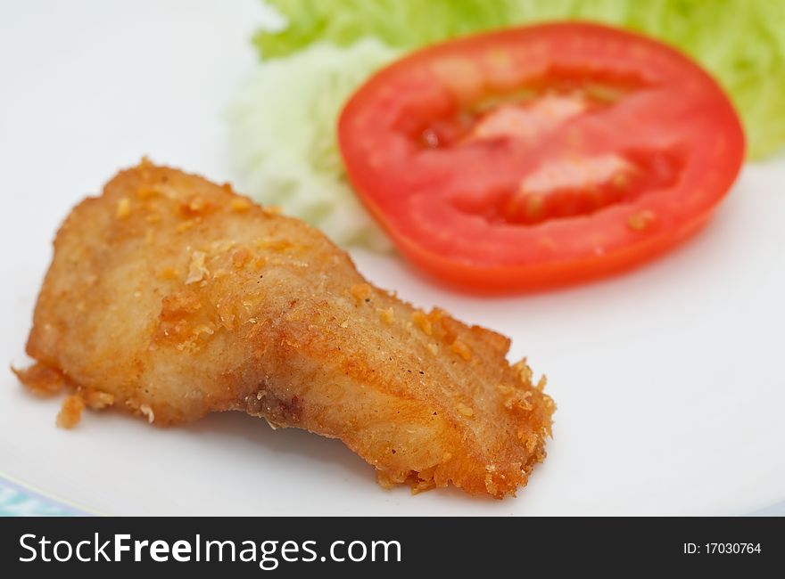 Piece of fried fish and vegetable. Piece of fried fish and vegetable