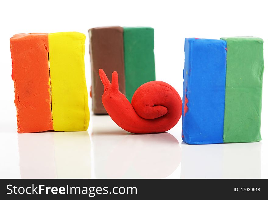 Snail and small blocks made out of plasticine in different colours. Snail and small blocks made out of plasticine in different colours