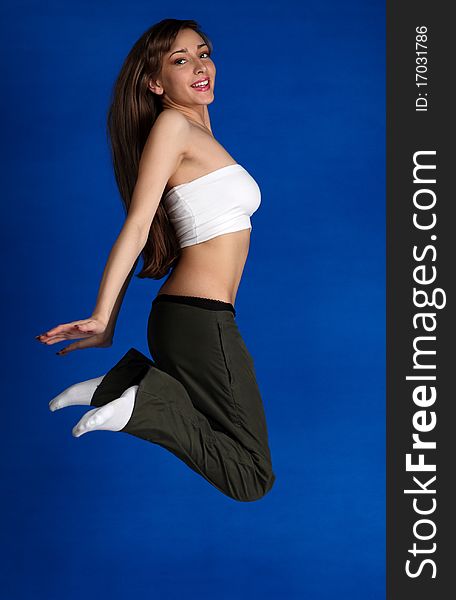 Young beautiful woman jumping in the studio. Young beautiful woman jumping in the studio