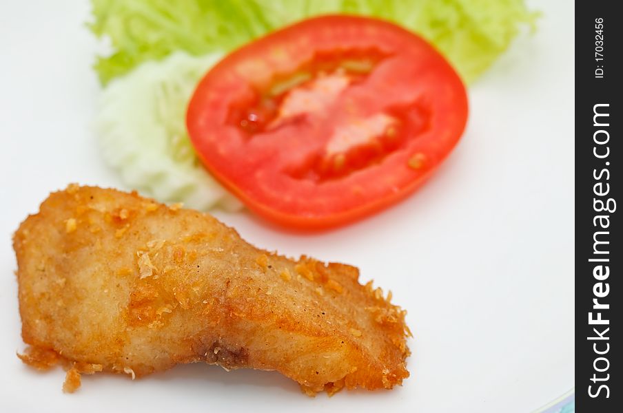 Piece of fried fish and vegetables