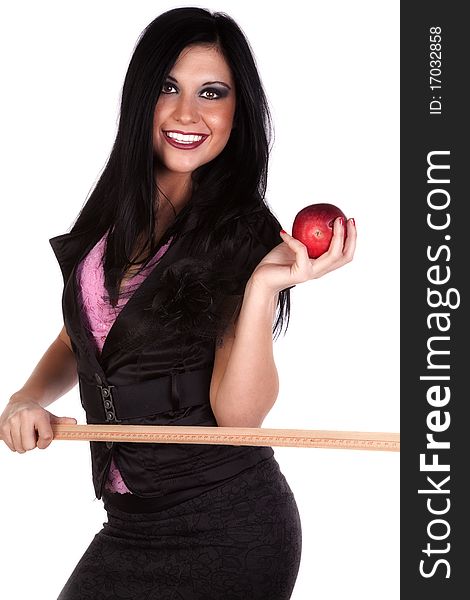 A woman is dressed like a teacher with a ruler in one hand and an apple in the other. A woman is dressed like a teacher with a ruler in one hand and an apple in the other.