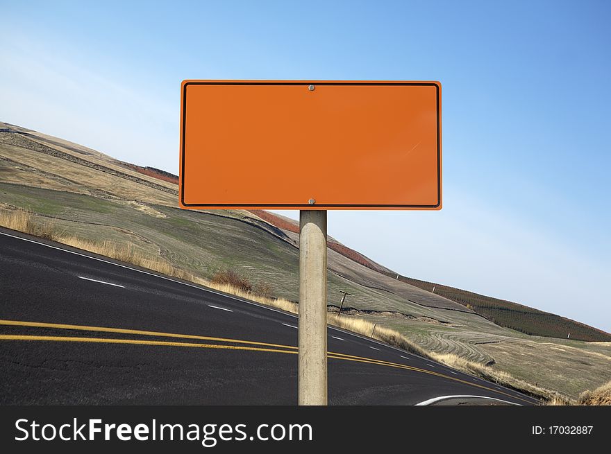 Blank orange construction sign outdoor day time asphalt highway on background
