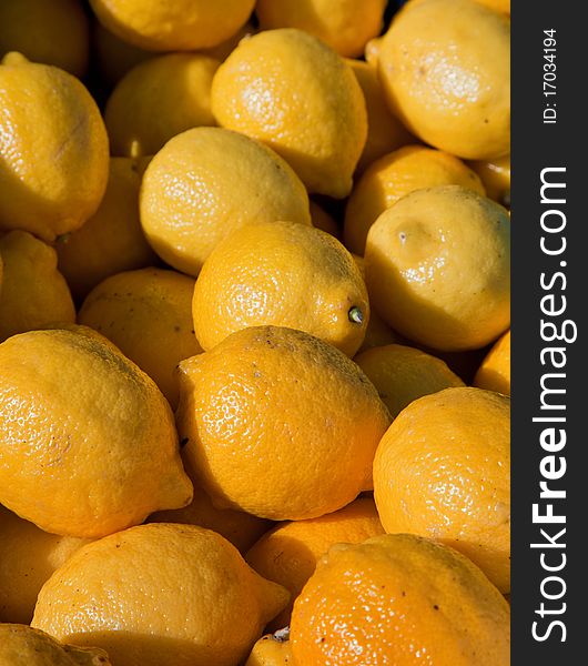 Fresh lemons piled high on a market stall