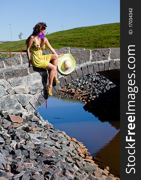 Happy Beautiful Girl Sitting On stone bridge